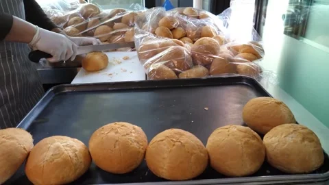 Bakery Worker Packing Freshly Baked Bread Buns onto Tray 스톡 동영상 343587340