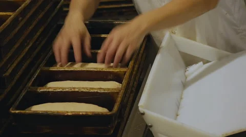 Bakery Worker Putting Bread Dough Into Pans At Commerical Bakery 库存影片 62042963