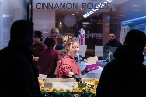 Bakery Worker Serving Cinnamon Rolls in Cafe Stock Photos