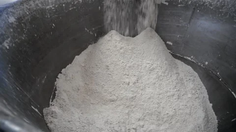 Bakery worker sifts flour through a special machine. Stock Footage 252931459