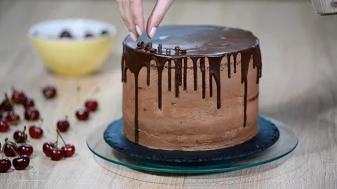 Baking and decorating chocolate cake. Cake decorating with chocolate. Stock Footage