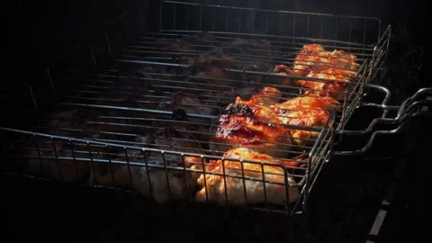 Baking and roasting marinated legs and wings chicken on barbecue grill. Stock Footage 169151546