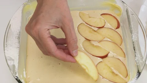 Baking Apple pie. Biscuit batter and sliced apples in a baking glass form. Stock Footage 129196599