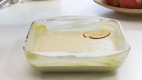 Baking apple pie. Close up of biscuit batter and sliced apples in a bowl on whit Stock Footage 142632720
