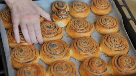 Baking background. Chef hands show hot fresh roll buns with poppy in the bakery. Video stock 101139601