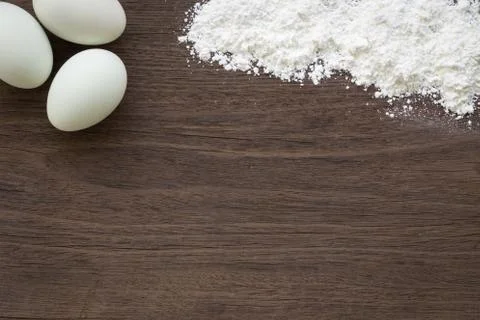 Baking background, eggs and flour on table Stock Photos