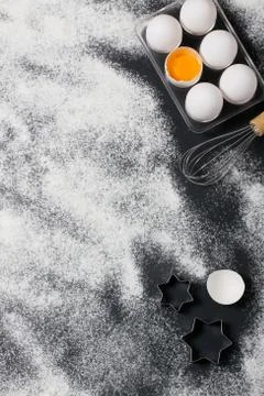 Baking background with eggs, rolling pin and star cookie cutters Stock Photos