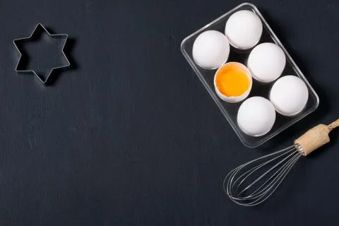 Baking background with eggs, whisk and star shape cookie cutters Stock Photos