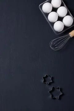 Baking background with eggs, whisk and star cookie cutter Foto stock
