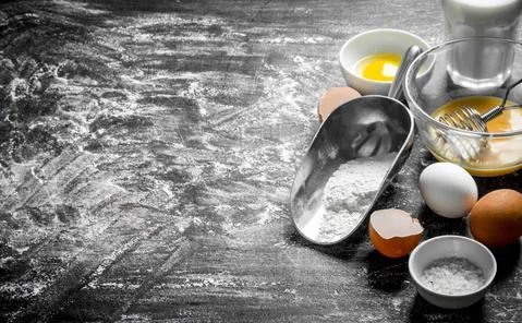 Baking background. Flour with eggs and milk. Stock Photos