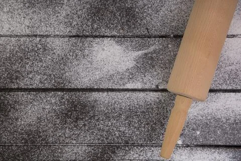 Baking background with free space for your text. Rolling pin and flour on bla Stock Photos