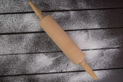 Baking background with free space for your text. Rolling pin and flour on bla Stock Photos