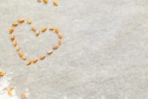 Baking background with heart from wheat grain Stock Photos