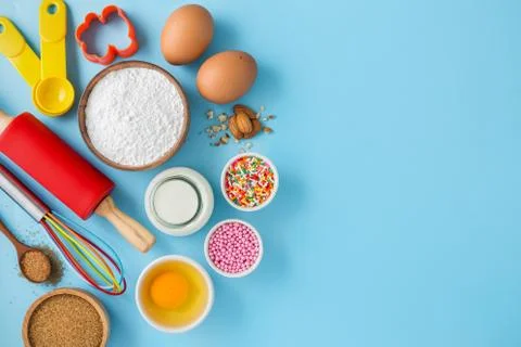 Baking background with ingredients eggs, flour, milk, sugar and cake decor on Stock Photos