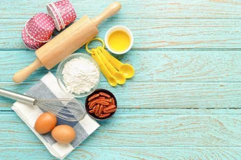 Baking background with ingredients flour eggs pecan nut olive oil and utensil Stock Photos