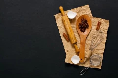 Baking background with kitchen tools on dark wood Stock Photos