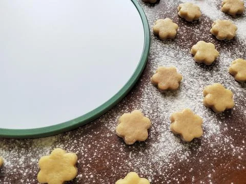 Baking background with raw coocies srars, flour and white round empty board Stock Photos