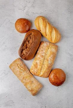 Baking background with several different fresh baked whole loaves of bread  Stock Photos