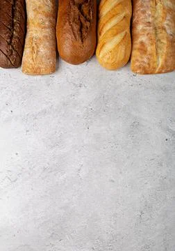 Baking background with various fresh baked whole loaves of bread flat lay  Stock Photos