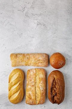 Baking background with various fresh baked whole loaves of bread  Stock Photos