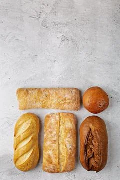 Baking background with various fresh baked whole loaves of bread flat lay o.. Stock Photos
