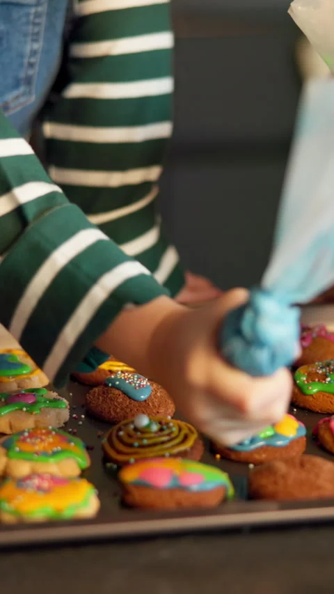 Baking, biscuits and piping bag with hands of people in kitchen together for Stock Footage 317159101