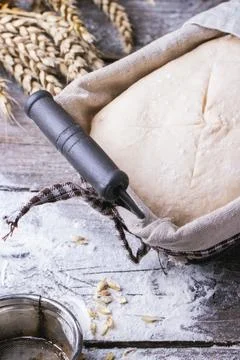 Baking bread. Close up of homemade dough in proofing basket on wooden table.. Stock Photos
