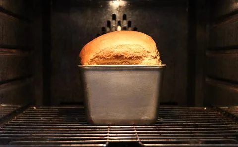Baking bread in an electric oven. Stock Photos