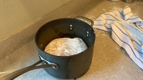 Baking Bread at Home, Transferring Dough to pot to Bake in the Oven Stock Footage 134215173