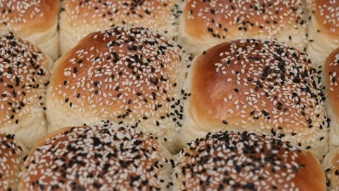 Baking bread rolls with sesame seeds in a warm kitchen Stock Footage 333166002