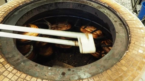 Baking bread in a traditional oven in a busy market Stock Footage 339827728