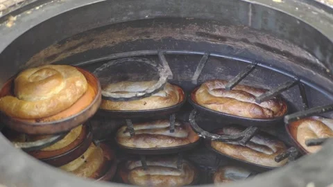 Baking bread in a traditional oven in a local town Stock Footage 336038856