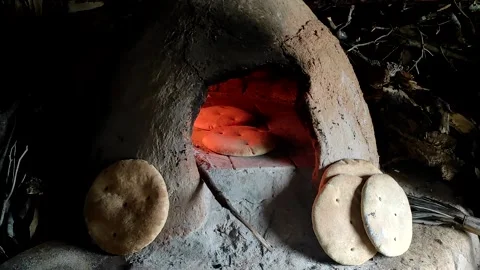 Baking bread in a traditional way in a wood fire oven and flatbread is Stock Footage 204775600