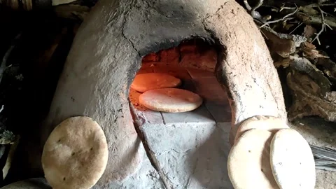 Baking bread in a traditional way in a wood fire oven and flatbread is Stock Footage 204775604