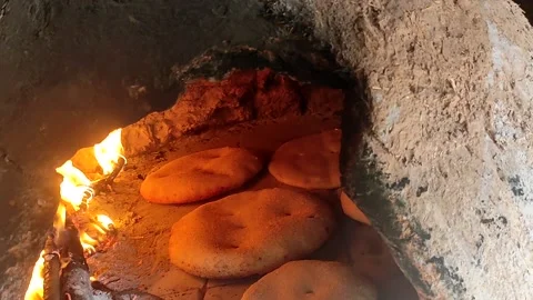 Baking bread in a traditional way in a wood fire oven and flatbread is Stock Footage 204775605