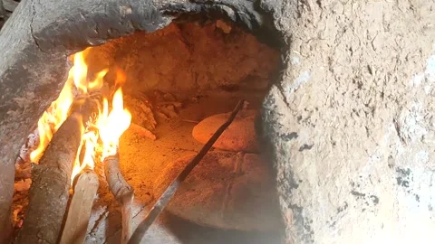 Baking bread in a traditional way in a wood fire oven and flatbread is Stock Footage 204776203
