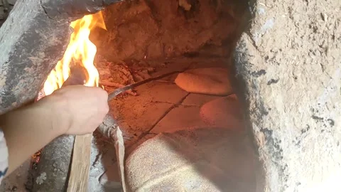Baking bread in a traditional way in a wood fire oven and flatbread is Stock Footage 204776204