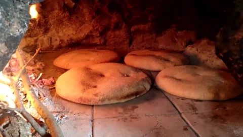 Baking bread in a traditional way in a wood fire oven and flatbread is Stock Footage 204776210