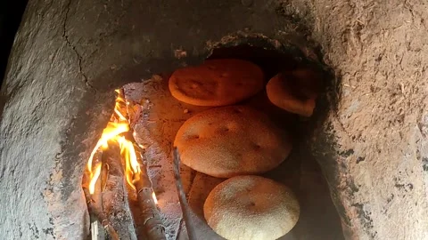 Baking bread in a traditional way in a wood fire oven and flatbread is Stock Footage 204777458