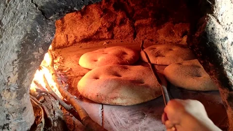 Baking bread in a traditional way in a wood fire oven and flatbread is Stock Footage 204777483
