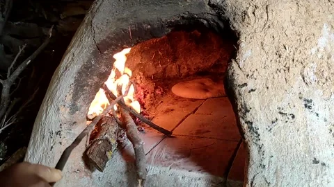 Baking bread in a traditional way in a wood fire oven and flatbread is Stock Footage 204777663