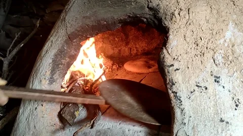 Baking bread in a traditional way in a wood fire oven and flatbread is Stock Footage 204778428
