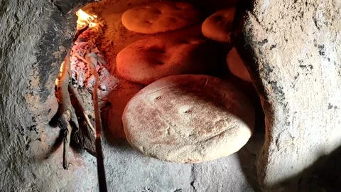 Baking bread in a traditional way in a wood fire oven and flatbread is Stock Footage 204778441