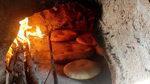 Baking bread in a traditional way in a wood fire oven and flatbread is Stock Footage 204781528