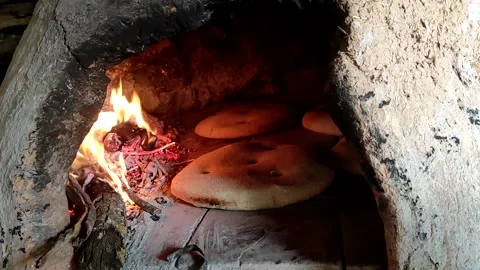 Baking bread in a traditional way in a wood fire oven and flatbread is Stock Footage 204781547