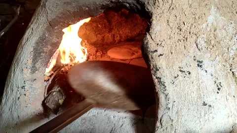 Baking bread in a traditional way in a wood fire oven and flatbread is Stock Footage 204781548