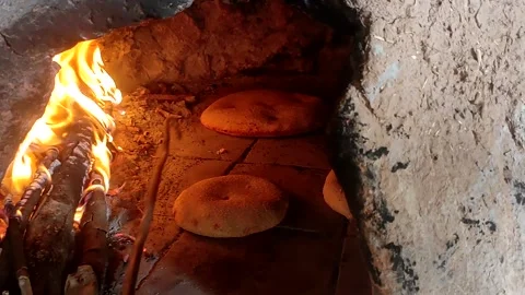 Baking bread in a traditional way in a wood fire oven and flatbread is Stock Footage 204781553