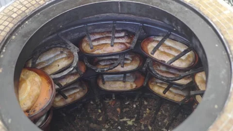 Baking bread in an underground oven in Mexico Stock Footage 332885784