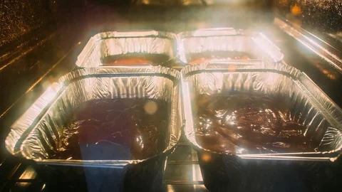 Baking brownies in the oven. Metal rectangular baking tin. Raisi Stock Footage 76141149
