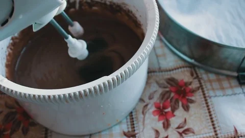 Baking a cake - mixing ingredients with an electric hand mixer Stock Footage